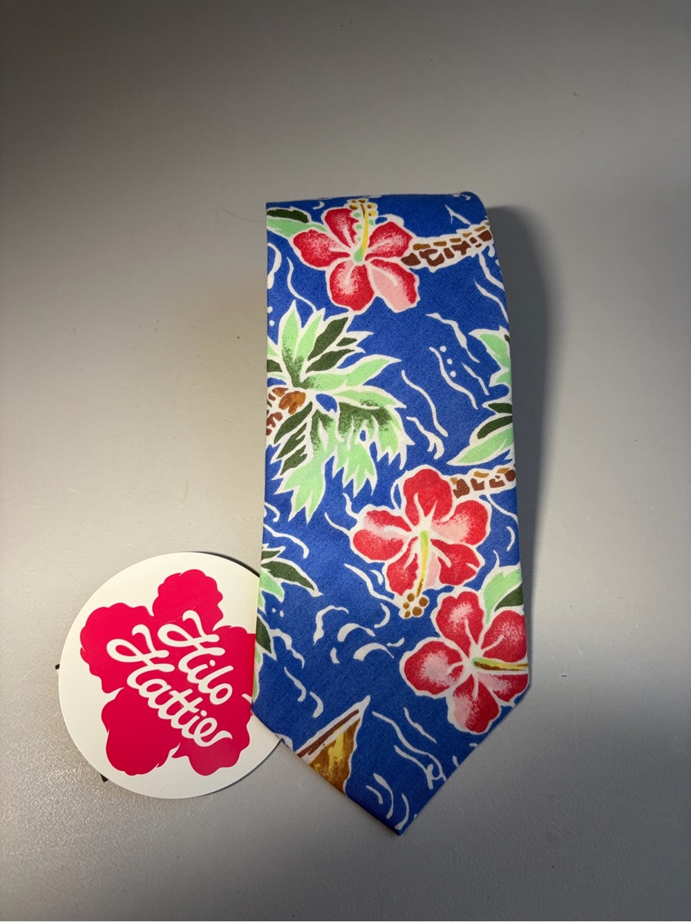 Hilo Hattie Bright Blue Tie with Coral Hibiscus and Green Palms